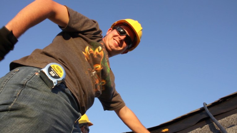 Construction technology major Joshua Willman Constributes to an Ivy Tech Northeast class project to reroof a model structure at Fort Wayne's Safety Village last fall.