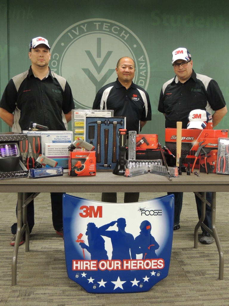 Ivy Tech Northeast automotive technology student Gabriel Davis (left) and graduate Paul Hyde (right) display $3,000 in tools and equipment that each individual selected as a recipient of the Collision Repair Education Foundation’s 3M Hire Our Heroes tool grant for 2015. Both men are joined by Randy Minobe, senior account representative with the 3M Automotive Aftermarket Division. Davis served in the Indiana Army National Guard for nearly eight years, and Hyde served in the U.S. Army for five years. From among the 35 tool grants awarded nationwide this year, Ivy Tech Northeast was one of only two colleges to have more than one recipient.