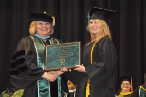 Ivy Tech Northeast Chancellor Jerrilee K. Mosier, Ed. D., presents an award plaque to respiratory care graduate Karrah Hughes.