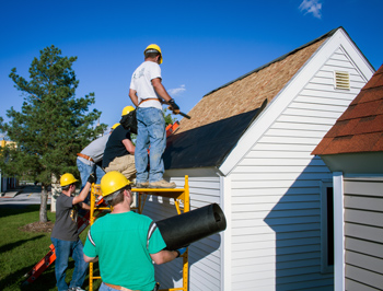 Fall 2014 construction technology students reshingle a roof for a Safety Village structure.