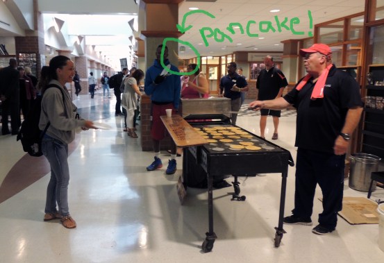 Trevor Muir flips a flapjack to a student on Thursday on the Coliseum Campus.