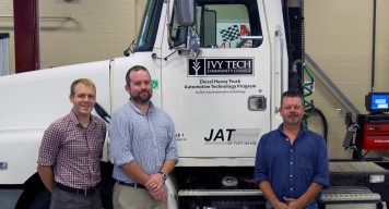 JAT of Fort Wayne has donated a semi-truck with a Detroit diesel engine, which allows Ivy Tech Northeast to begin offering diesel classes in spring 2016. From left: Automotive technology instructors David Jones and Nick Goodnight and automotive technology program chair Robert Huffman.
