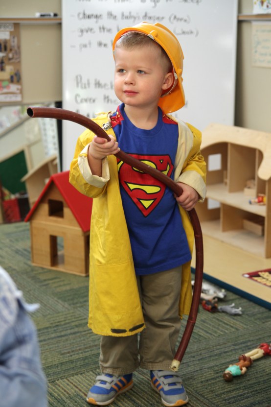 Preschooler Winston Unger, 3, prepares to confront a pretend fire.