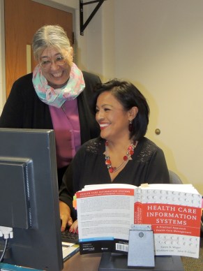 Lucy La Hurreau, Ivy Tech Northeast assistant professor of health information technology, interacts with one of her program’s graduates, Celia Dull. Dull, a registered coder at Jay County Hospital in Portland, Ind., considers La Hurreau a mentor and colleague. 